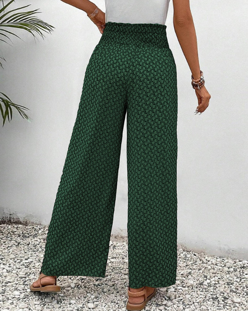 Model wearing comfortable women's wide leg trousers with geometric print. Relaxed fit, fashion statement.