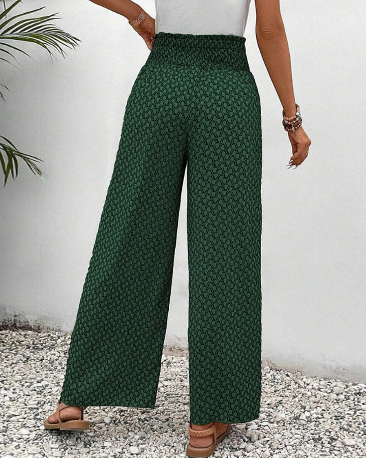 Model wearing comfortable women's wide leg trousers with geometric print. Relaxed fit, fashion statement.