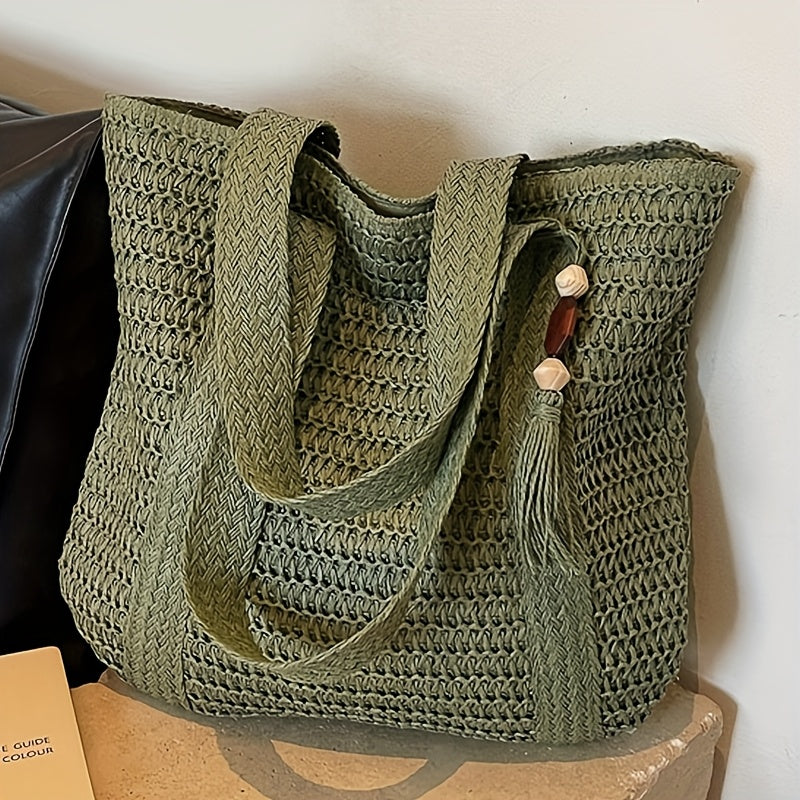 Boho-chic women's natural fiber straw shoulder bag with fringe, ideal as a summer purse.