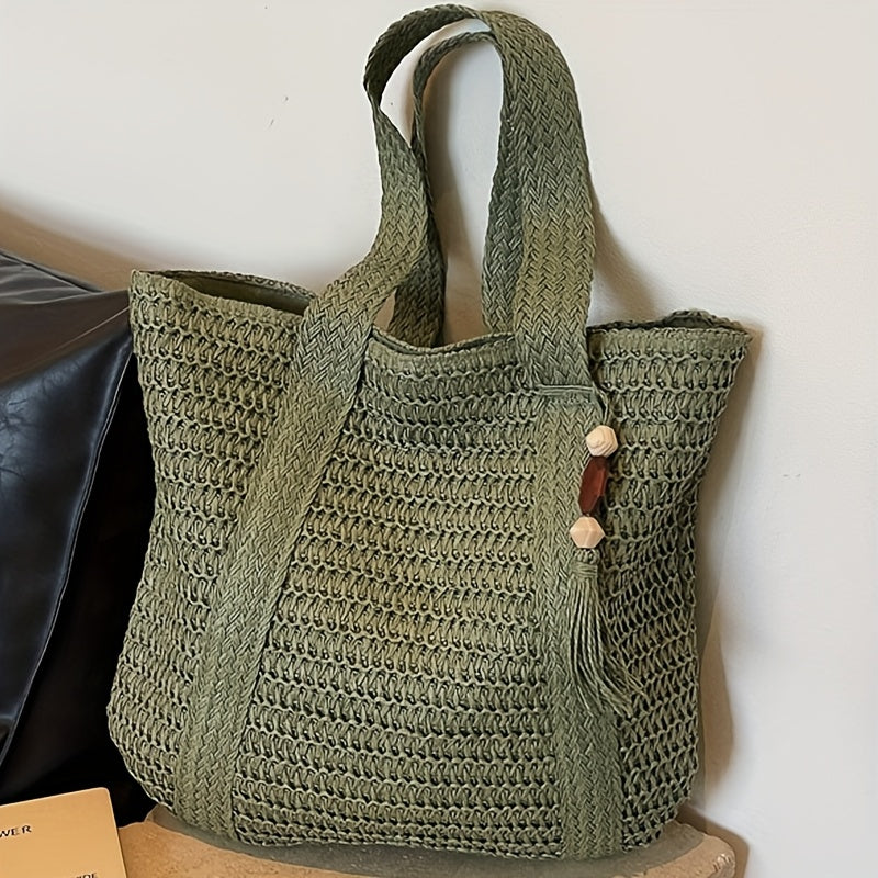 Kaqise women's woven straw handbag featuring a playful fringe tassel for a bohemian look.