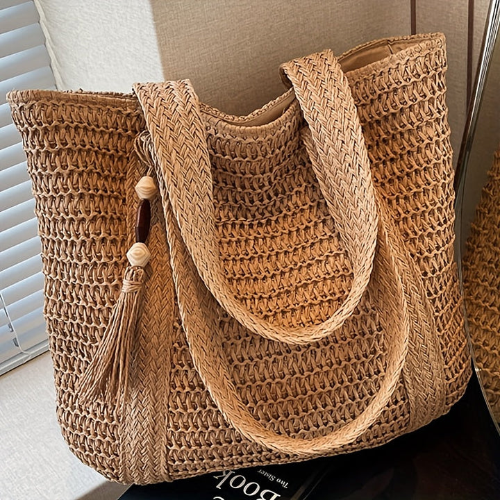 Stylish straw shoulder bag with woven texture & fringe tassel, a versatile women's summer purse.