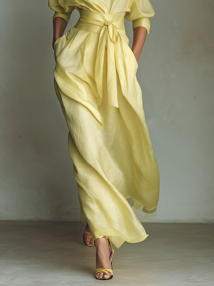 Full-length view of women's vibrant yellow maxi shirt dress, perfect for casual or resort occasions.