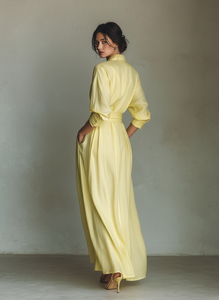 Flowing yellow elegant maxi shirt dress, women's v-neck style with graceful billowy sleeves & tie waist.