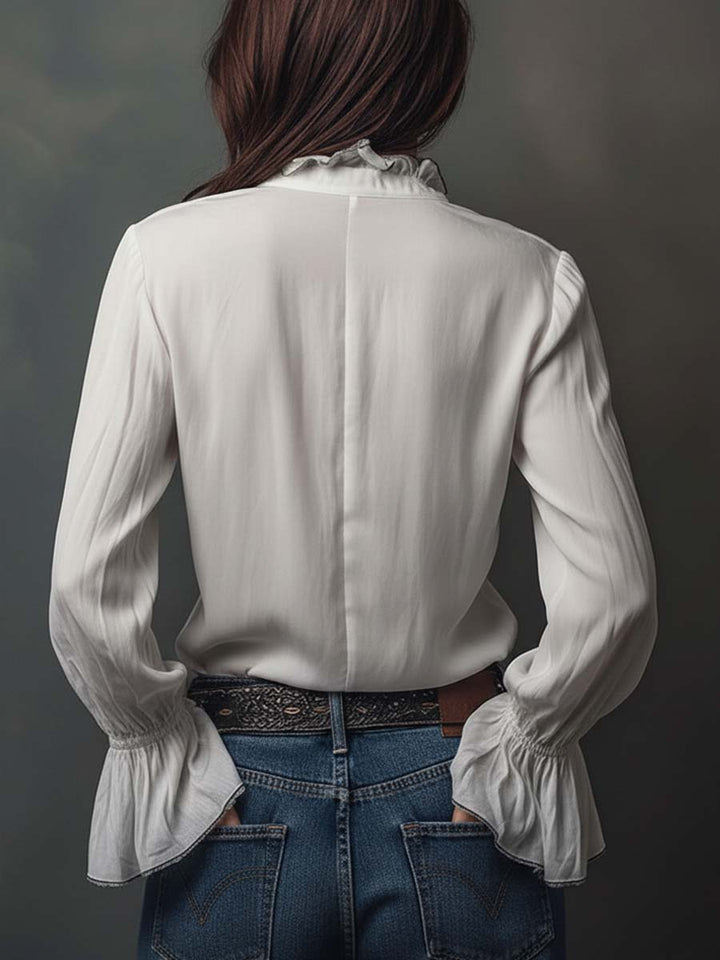 Chic women's blouse with an easy zip-front and refined bell cuffs; a versatile piece for office or leisure.