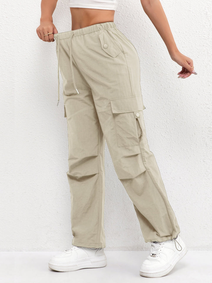 Women's utility cargo parachute pants with functional pockets & drawstring waist, offering a trendy loose fit.
