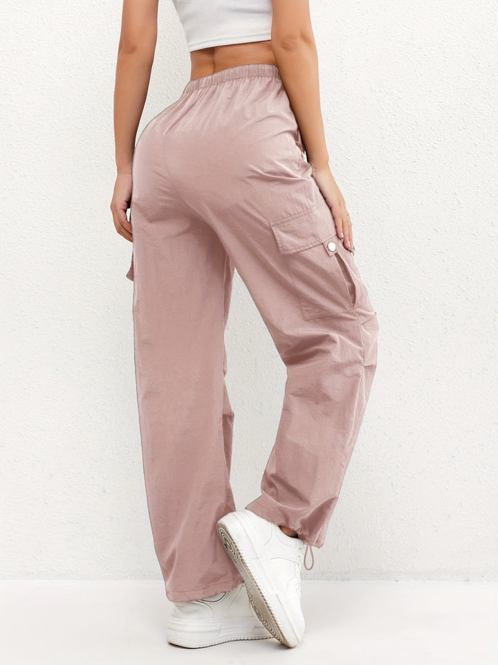Modern women's parachute pants with drawstring waist, loose fit, and cargo pockets for a trendy streetwear vibe.
