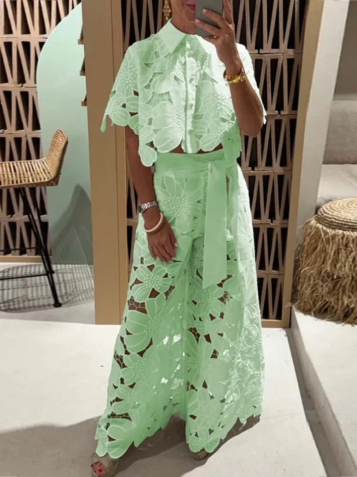 Fashionable women's two-piece set featuring floral lace cropped top & wide leg pants. Spring & summer style.