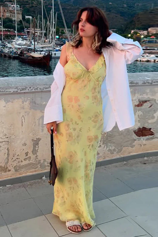 Yellow floral maxi dress with delicate spaghetti straps, ideal for summer elegance and events.