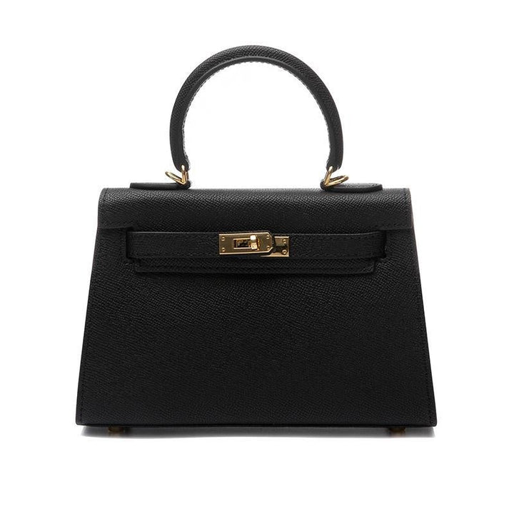 Elegant black structured bag for women, featuring a sturdy top handle, practical turn lock, & adjustable strap.