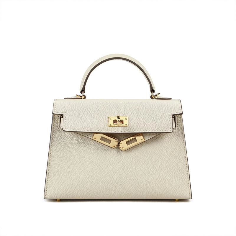Chic brown women's shoulder bag, structured design with a top handle & secure turn lock, ideal for fashion.