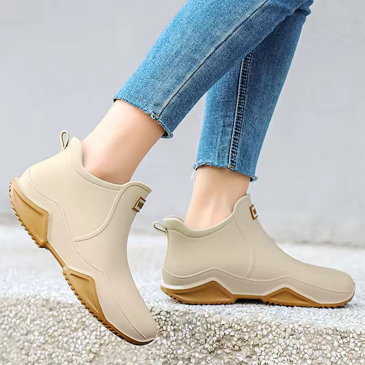 Red women's weatherproof ankle rain boots, waterproof and convenient slip-on style.