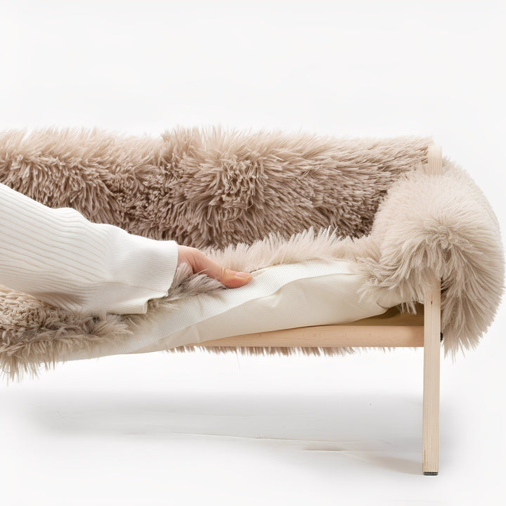 Raised wooden pet cot for dogs, featuring a durable frame and breathable fabric. Ideal for pet comfort.